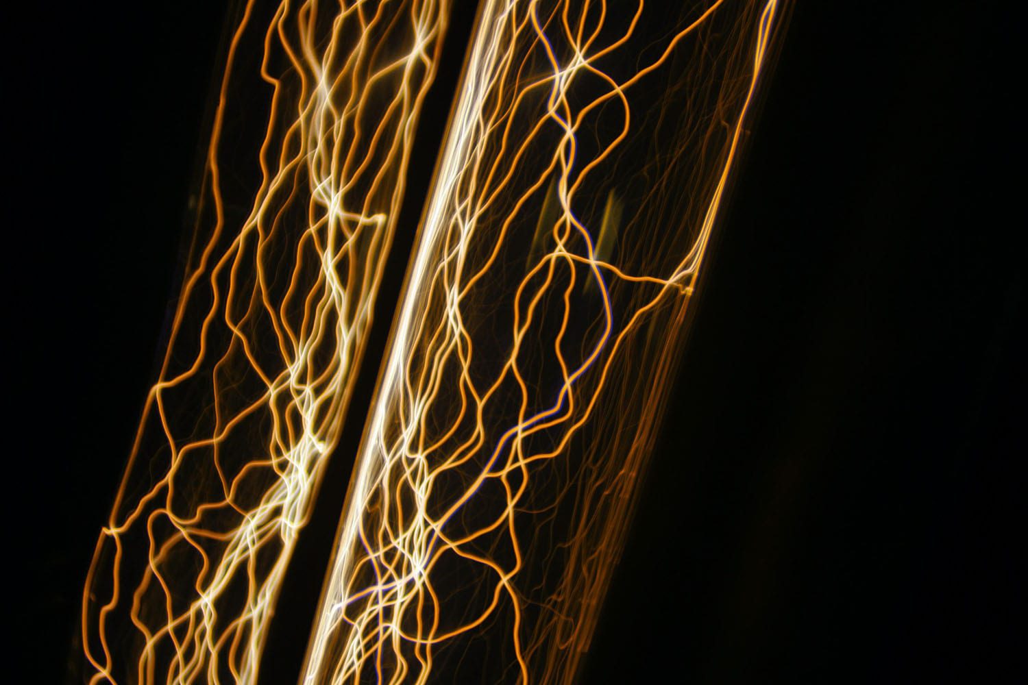 yellow-looking electrical current lines with a black background