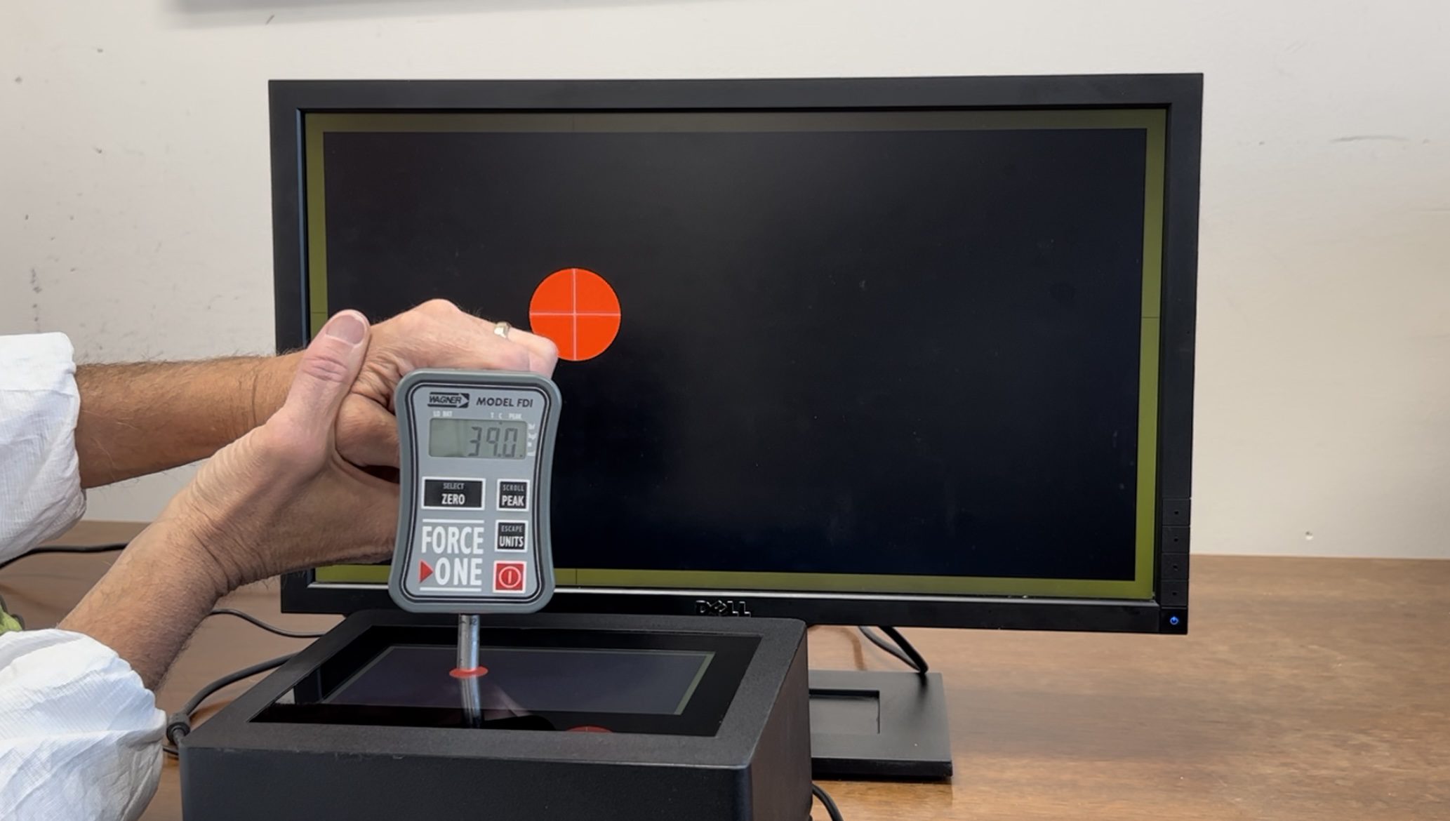 a force sensor attached to a monitor touchscreen